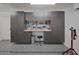 Garage with epoxy flooring and a work bench with plenty of storage at 5719 E Paradise Ln, Scottsdale, AZ 85254