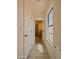 Bright hallway with light walls, wood-look flooring, and a window, creating an inviting and airy passage at 5719 E Paradise Ln, Scottsdale, AZ 85254