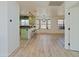 An open-concept kitchen with light green cabinetry, counter seating, and natural light at 5719 E Paradise Ln, Scottsdale, AZ 85254