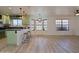 Modern kitchen featuring light green cabinetry, black countertops, and a breakfast bar at 5719 E Paradise Ln, Scottsdale, AZ 85254