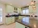 Bright kitchen with a peninsula island and stainless steel appliances, and granite countertops at 5719 E Paradise Ln, Scottsdale, AZ 85254