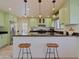 Stylish kitchen with light green cabinets, granite countertops, and stainless steel appliances at 5719 E Paradise Ln, Scottsdale, AZ 85254