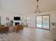 Spacious living room with a fireplace, bright lighting, and open access to the backyard at 5719 E Paradise Ln, Scottsdale, AZ 85254