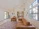 Bright living room with vaulted ceilings, large windows, and modern furnishings at 5719 E Paradise Ln, Scottsdale, AZ 85254