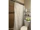 Cozy bathroom featuring a patterned shower curtain and modern fixtures at 5815 N 61St Ln, Glendale, AZ 85301