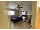 This bedroom features a ceiling fan and tile floors at 5815 N 61St Ln, Glendale, AZ 85301