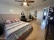 This bedroom features a ceiling fan, tile floors and a closet with mirrored doors at 5815 N 61St Ln, Glendale, AZ 85301