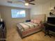 This bedroom features a ceiling fan, a window, and a pink bed at 5815 N 61St Ln, Glendale, AZ 85301