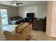 Spacious living room with comfortable seating, a large tv and stylish decor at 5815 N 61St Ln, Glendale, AZ 85301