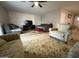 Inviting living area showcasing ample seating, a large tv, and decorative rugs at 5815 N 61St Ln, Glendale, AZ 85301