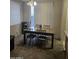Dining room with natural light from window with blinds and a table with chairs at 6629 W Polk St, Phoenix, AZ 85043