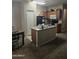 View of a kitchen featuring an island, wooden cabinets, and a refrigerator at 6629 W Polk St, Phoenix, AZ 85043