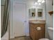 Well-organized bathroom featuring a stylish vanity, mirror, and shower for convenience at 67 S Amulet Ave, Mesa, AZ 85208