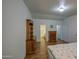Bedroom featuring classic furniture and ensuite access to a well-lit bathroom at 67 S Amulet Ave, Mesa, AZ 85208