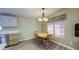 Cozy dining room with vinyl floors, a hanging light, and window views at 67 S Amulet Ave, Mesa, AZ 85208