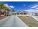 Charming single-story home featuring a front porch, covered parking, and desert landscaping at 67 S Amulet Ave, Mesa, AZ 85208