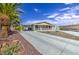 Exterior showing a well-maintained driveway, front porch, and low-maintenance desert landscaping at 67 S Amulet Ave, Mesa, AZ 85208