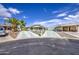 Wide shot showing the home's front with a spacious driveway and well-maintained desert landscaping at 67 S Amulet Ave, Mesa, AZ 85208