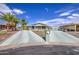 View of the home's front yard, showing desert landscaping, parking, and an inviting entrance at 67 S Amulet Ave, Mesa, AZ 85208