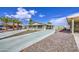 Charming front exterior with well-maintained desert landscaping, carport, and cozy front porch at 67 S Amulet Ave, Mesa, AZ 85208