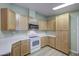 Bright kitchen features updated cabinets and modern appliances, ample countertop space, and lots of storage at 67 S Amulet Ave, Mesa, AZ 85208