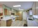 Bright kitchen features updated cabinets, white appliances, and light countertops at 67 S Amulet Ave, Mesa, AZ 85208
