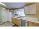Modern kitchen with white countertops, stainless steel dishwasher, and lots of light at 67 S Amulet Ave, Mesa, AZ 85208