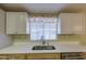 Charming kitchen sink with stainless steel faucet, ample countertop space, and lots of light at 67 S Amulet Ave, Mesa, AZ 85208