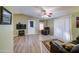 Inviting living room with vinyl floors, ceiling fan, and door to a patio at 67 S Amulet Ave, Mesa, AZ 85208