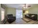 Inviting living room with vinyl floors, ceiling fan, and sliding glass doors to a patio at 67 S Amulet Ave, Mesa, AZ 85208