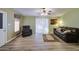 Inviting living room with vinyl floors, ceiling fan, and sliding glass doors to a patio at 67 S Amulet Ave, Mesa, AZ 85208