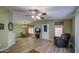 Inviting living room showcasing vinyl floors, ceiling fan, and door to the exterior at 67 S Amulet Ave, Mesa, AZ 85208