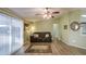 Bright living room featuring vinyl floors, ceiling fan, and sliding doors to a patio at 67 S Amulet Ave, Mesa, AZ 85208