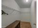 Bright walk-in closet with built-in shelving and a stylish cabinet for optimal storage solutions at 67 S Amulet Ave, Mesa, AZ 85208