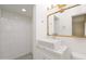 Modern bathroom with a walk-in shower, marble countertop, and decorative mirror at 7041 E Cypress St St, Scottsdale, AZ 85257