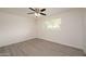 Bright bedroom with gray flooring, ceiling fan, and a window offering natural light at 7041 E Cypress St St, Scottsdale, AZ 85257