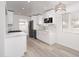 Well-lit kitchen with white cabinets, modern appliances, and a stylish hanging light fixture at 7041 E Cypress St St, Scottsdale, AZ 85257
