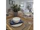 Dining room table setting with living room and white sofa in the background at 7350 N Via Paseo Del Sur -- # P107, Scottsdale, AZ 85258