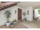 Inviting entrance with stylish potted plants, textured walls, and warm lighting that lead to a cozy home interior at 7350 N Via Paseo Del Sur -- # P107, Scottsdale, AZ 85258