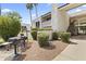 Well-maintained condo exterior featuring a private outdoor grill area and lush landscaping, perfect for relaxed outdoor living at 7350 N Via Paseo Del Sur -- # P107, Scottsdale, AZ 85258