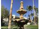 Beautiful tiered fountain with palm trees in a grassy, well maintained common area at 7350 N Via Paseo Del Sur -- # P107, Scottsdale, AZ 85258
