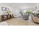 Bright, airy living room with hardwood floors, a plush white sofa, and a seamless indoor-outdoor flow at 7350 N Via Paseo Del Sur -- # P107, Scottsdale, AZ 85258
