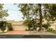 Exterior view of the home with a two-car garage, mature trees and shrubs at 7500 E Mccormick Pkwy # 73, Scottsdale, AZ 85258