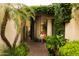 Inviting front entrance with brick pathway, lush greenery, and a charming bench at 7500 E Mccormick Pkwy # 73, Scottsdale, AZ 85258