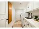 Well-organized laundry room with a sink, plenty of storage, and stacked washer and dryer at 7500 E Mccormick Pkwy # 73, Scottsdale, AZ 85258