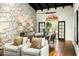 Spacious living room with stone wall, ceiling fans, and hardwood floors at 7500 E Mccormick Pkwy # 73, Scottsdale, AZ 85258