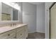 Bathroom featuring a vanity with marble countertop and a frameless glass shower door at 7675 E Mcdonald Dr # 107, Scottsdale, AZ 85250