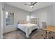 Bedroom with large bed, tile floors, modern decor, and natural light from two windows at 7675 E Mcdonald Dr # 107, Scottsdale, AZ 85250