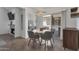 Dining area with contemporary table and chairs, adjacent to living room and fireplace at 7675 E Mcdonald Dr # 107, Scottsdale, AZ 85250