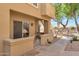 Exterior view showcasing a ground-level unit, landscaped walkway, and building features with outdoor stair access at 7675 E Mcdonald Dr # 107, Scottsdale, AZ 85250